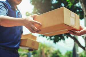 Delivery man delivering holding parcel box to customer